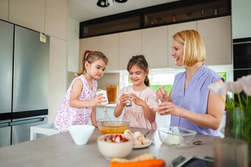 Family cooking together in a cozy kitchen on a sunny day