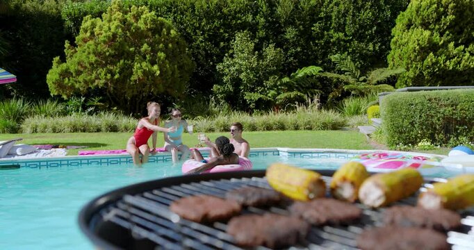 Grill smoke wafting, Diverse friends passing bottles, clinking cups, sipping and laughing poolside