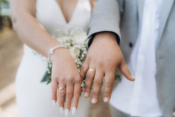 Hands of bride and groom with wedding rings. Newly wed couple's hands.