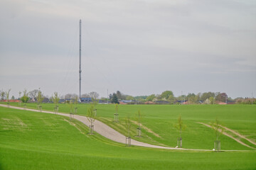 The way to Kollundgaard is an idyllic path between with green trees, with the Kollund radio tower