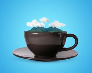 Clouds above mountains in cup against light blue background