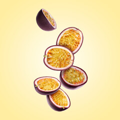 Delicious cut passion fruits falling on pale yellow gradient background