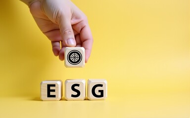 ESG concept of environmental, social and governance. Sustainable corporation development. Hand flips wooden cubes with target setting  to ESG icon with other ESG icons on bright background.Copy space.