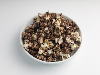 Popcorns on white bowl, isolated on white