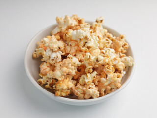 Popcorns on white bowl, isolated on white