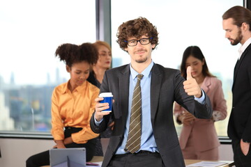 Diverse Team Working Together in Modern Co-Working Space. Casual meeting of smiling diverse business team analyzing financial data. Multiethnic business people working together in the office.
