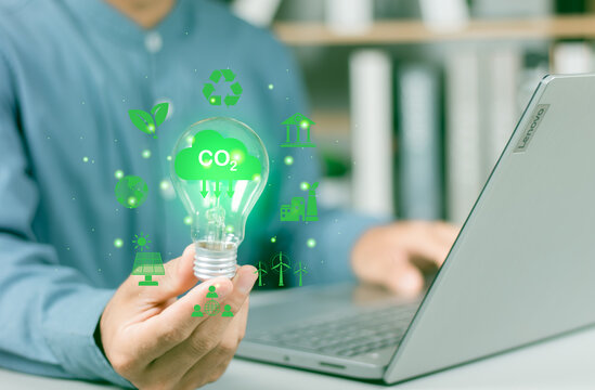 Reduce CO2, sustainability and Net zero carbon neutral.ESG environmental and Innovation through inspiration ideas concept.Person hand holding light bulb for starting new to investment environment.