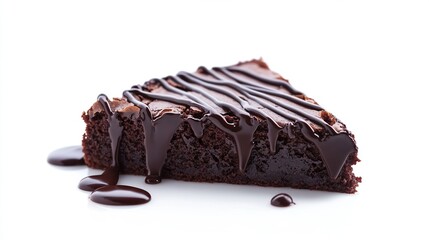 A triangular slice of rich, dark chocolate brownie, generously drizzled with a glossy chocolate ganache, rests on a white background; chocolate flows down the sides