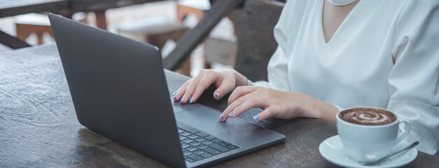 Banner Woman typing laptop computer online meeting at home office work from home. Asian...