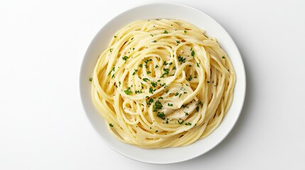 Overhead shot of a plate of spaghetti coated in a creamy sauce, garnished with freshly chopped herbs, set against a stark white background