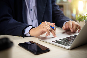 Businessman using computer laptop in modern office. business strategy planning, analysis, and corporate productivity online working.