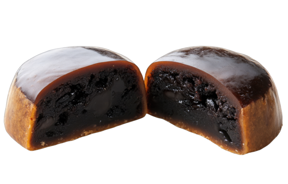 Dark, glossy, round sweets, halved