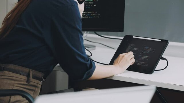 Two asian team working development of programming and encryption technology website design programmers on desk in office