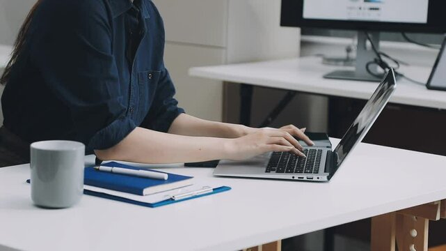 Two asian team working development of programming and encryption technology website design programmers on desk in office