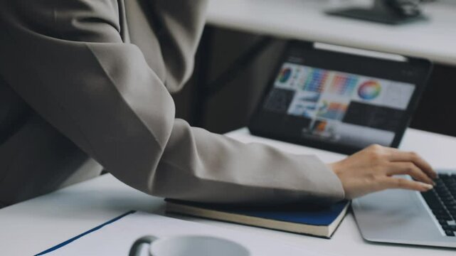 Two asian team working development of programming and encryption technology website design programmers on desk in office