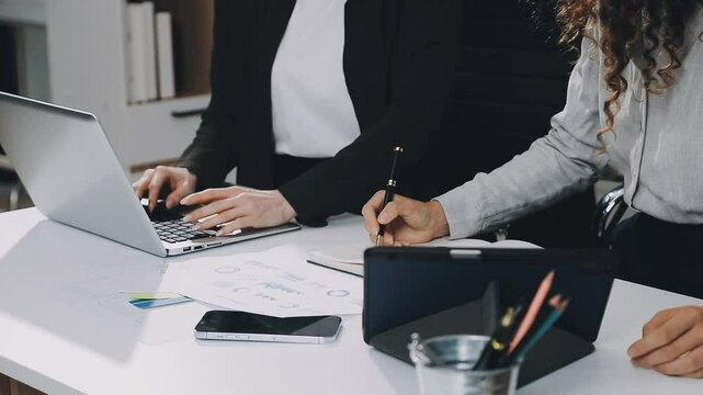 Two asian team working development of programming and encryption technology website design programmers on desk in office