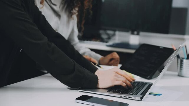 Two asian team working development of programming and encryption technology website design programmers on desk in office