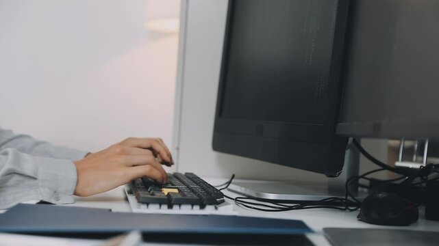Two asian team working development of programming and encryption technology website design programmers on desk in office