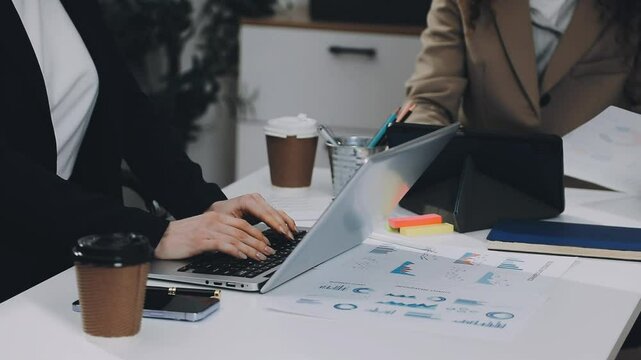 Two asian team working development of programming and encryption technology website design programmers on desk in office