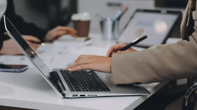 Two asian team working development of programming and encryption technology website design programmers on desk in office