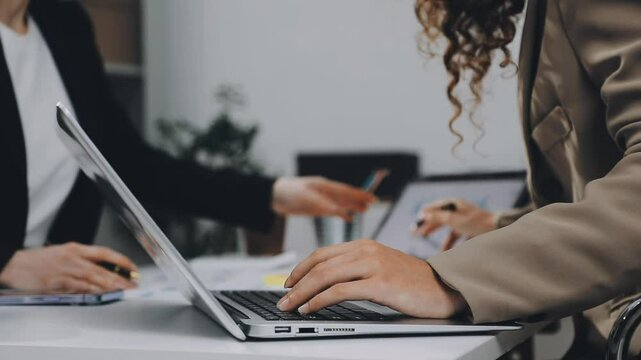 Two asian team working development of programming and encryption technology website design programmers on desk in office