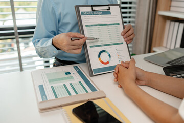 the company's auditing staff is checking the documents for accuracy in the office, businessman is explaining information in a document to his partner, graph, entrepreneur, marketing