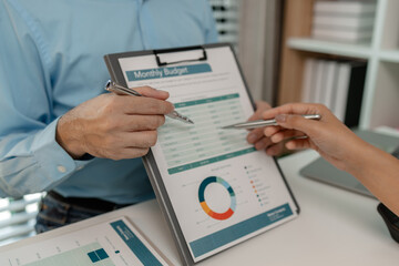 the company's auditing staff is checking the documents for accuracy in the office, businessman is...