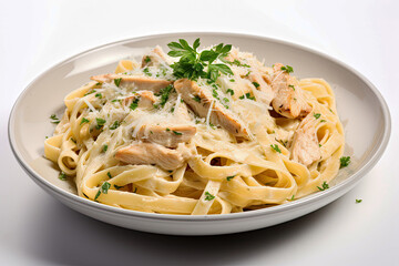 Close up of fettuccine alfredo pasta with chicken parmesan and parsley on white background Italian food