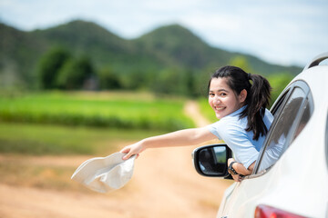People young woman traveler and tourism go to trips travel on hatchback car to destination leisure travel on the road forest in holiday vacations.  Happy and Enjoy trip adventure.  Travel Concept