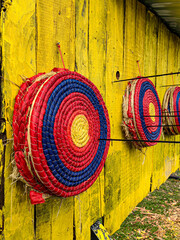 Colored targets and arrows on medieval festival yellow wooden background