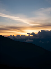 Fototapeta premium Sunset on mountain landscape of altocumulus and nimbostratus clouds in timelapse