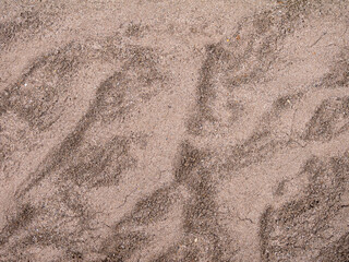Abstract patterns on sand, texture. Brown sand background, wallpaper.