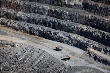 Yellow trucks inside an open-cast gold mine in Australia 