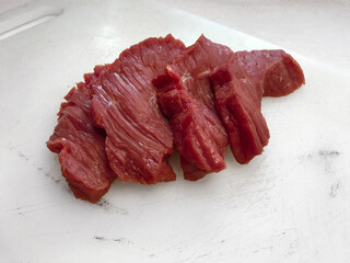 Fresh meat cut (beef) lying on white background