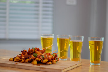 A group of young people gather and celebrate a simple beer party to share a special meal filled with laughter, conversation and friendship at an intimate dining celebration.