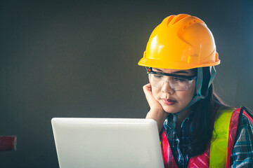 Engineer carefully inspecting construction plan data using a laptop computer on the job site.