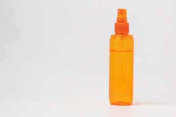 Orange Spray Bottle With Liquid Isolated on White Background
