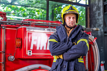 Firefighters in fire fighter safety suit stand in front of Fire truck in emergency situation.. - Safety Firefighter and industrial concept.