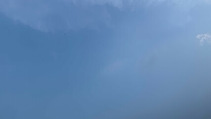 Fototapeta premium Bright Blue Sky with Faint Wisps of Clouds Creating a Soft Atmosphere