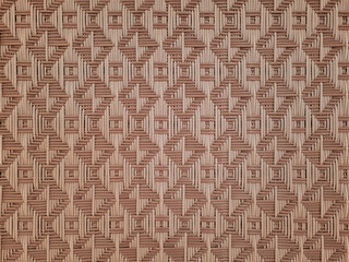 Close-up view of a traditional woven bamboo pattern with geometric symmetry and natural brown tones, perfect for backgrounds, textures, or interior design elements.