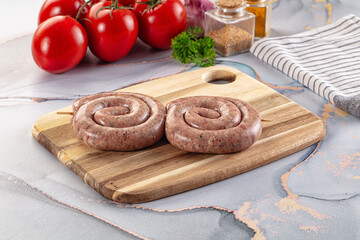 Raw meat pork and beef swirl sausages