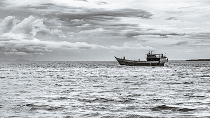 boat on the sea in black and white