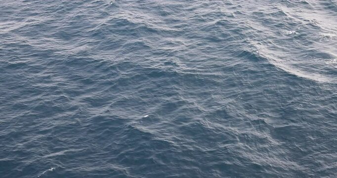Pacific deep ocean wake side cruise ship. Destination vacation travel tropical ocean sea. Caribbean cruise. Beautiful blue Ocean water. Powerful propeller wash and fluid dynamic cause a pattern.