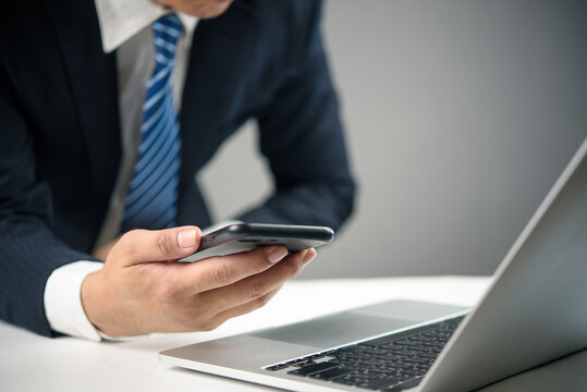 businessman hand holding smartphone digital communication and business management. modern technology, and global interaction, online working , social media and financial concepts. - Powered by Adobe