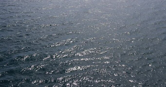 Pacific ocean sun glare Mexico from boat 4K. Destination vacation travel tropical ocean sea. Caribbean cruise. Beautiful blue Ocean water. Powerful propeller wash and fluid dynamic cause a pattern.