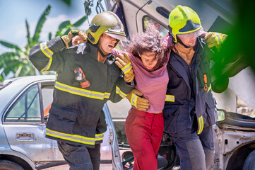 Firefighter emergency rescue help young woman from dangerous smoke and burning accident. - Safety and rescue operation comcept