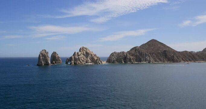 Cabo San Lucas Mexico land end arch from boat. Resort city at southern tip of the Baja California peninsula. Beach eco tourism economy. Commercial seaport. Ocean destination vacation and business.
