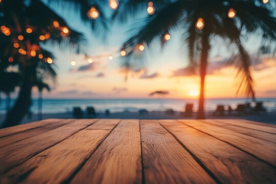 Wooden table top overlooking a beach at sunset.