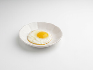 Sunny side up egg on white plate, isolated