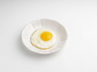 Sunny side up egg on white plate, isolated